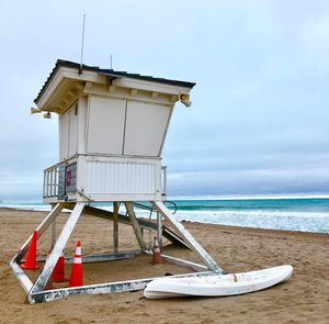 Lifeguard hut on beach against sky