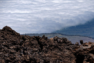 Scenic view of sea and mountains against sky