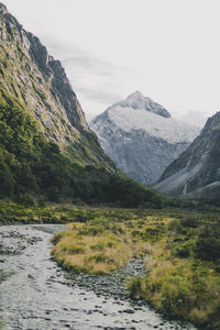 Scenic view of lake by mountains against sky