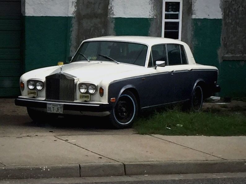 CAR PARKED ON STREET AGAINST BUILDING