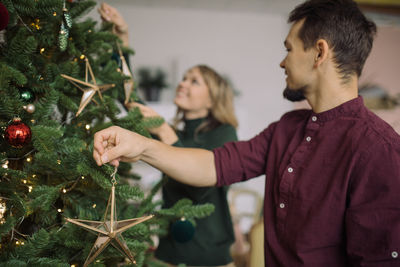 Midsection of woman with christmas tree