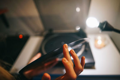 Cropped hand of person holding compact disc