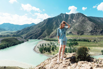 Full length of man standing on mountain against sky