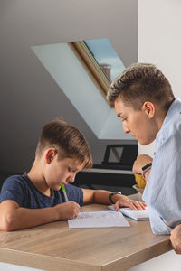 Happy boy holding table
