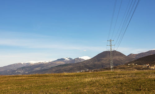 Scenic view of mountains against blue sky