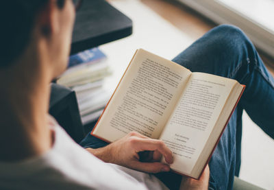 Midsection of person holding book