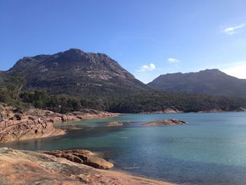 Scenic view of beach against blue sky