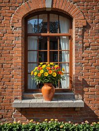 Potted plant against brick wall