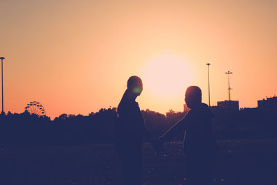 Silhouette people at sunset