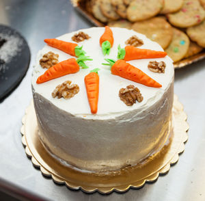 Carrot cake with cream cheese frosting and little carrots on top