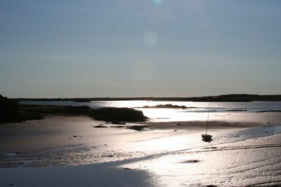 Scenic view of beach against sky during sunset