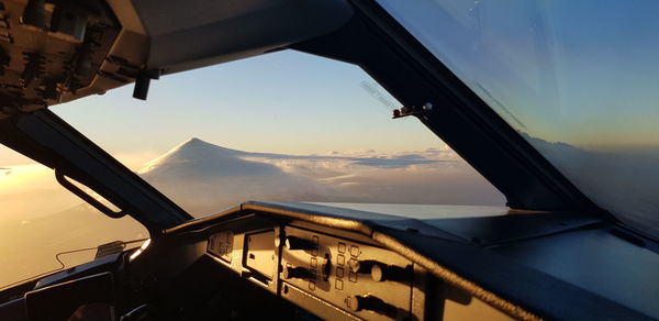 Airplane flying in sky during sunset