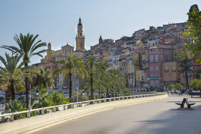 Buildings in city against clear sky