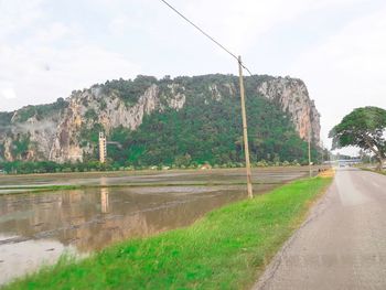 Road by mountain against sky