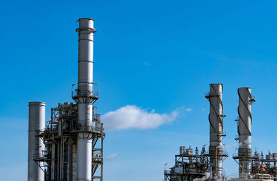 Low angle view of smoke stack against sky