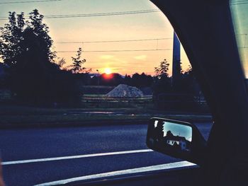 Cars on road at sunset