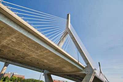 Low angle view of suspension bridge against clear blue sky