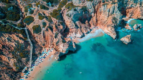 High angle view of rocks on sea shore