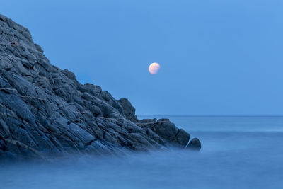 Scenic view of sea against clear blue sky