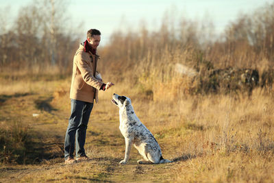 Full length of a dog standing on field