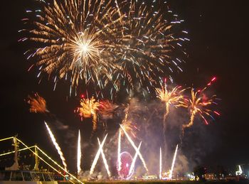 Low angle view of firework display at night