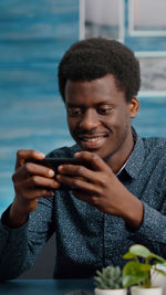 Portrait of smiling young man holding water