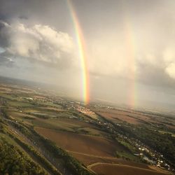 Scenic view of rainbow over city