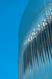 Low angle view of modern building against clear blue sky