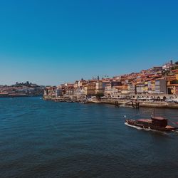 Boat sailing into porto city background 