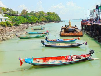 Boats moored in sea against sky