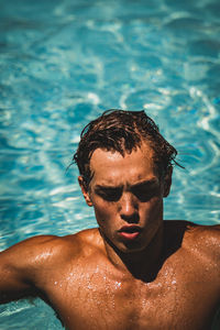 Portrait of young man swimming in pool