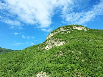 Scenic view of mountains against cloudy sky