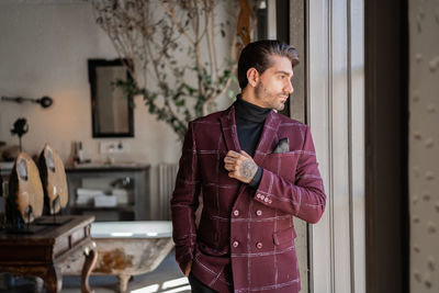 Young man standing at home