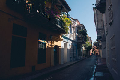 Empty alley amidst buildings in city