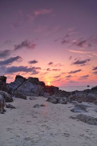 Scenic view of beach against sky during sunset