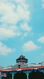 Low angle view of building against cloudy sky