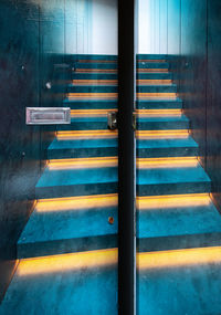 Empty staircase seen through glass door