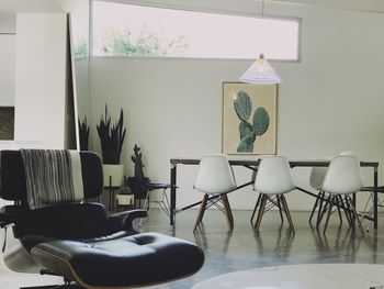 Empty chairs and table against wall at home