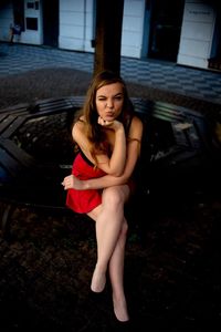 Portrait of young woman sitting outdoors