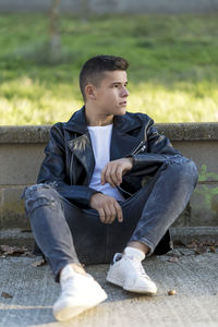 Portrait of young man sitting on bench