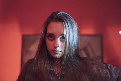 Portrait of beautiful woman against picture frame and wall