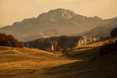 Scenic view of landscape and mountains against sky