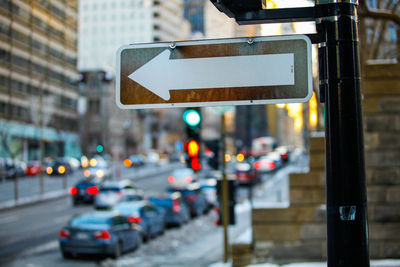 View of road sign on road in city