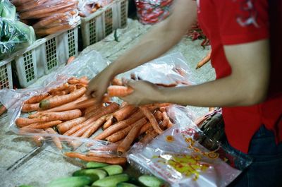 High angle view of woman preparing food at market stall