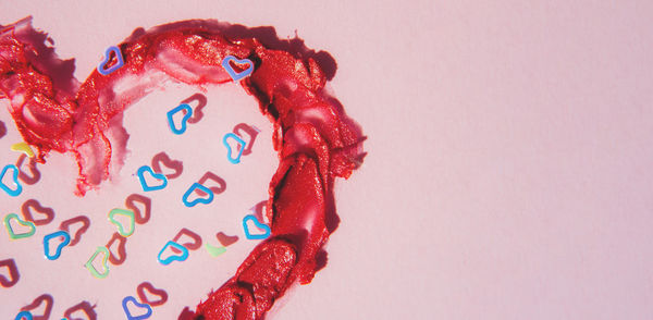 Heart drawn with red lipstick close-up. glitter sequins in the shape of a heart. 