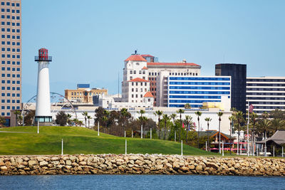 Buildings in city against clear sky