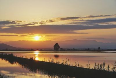 Scenic view of lake against sky during sunset