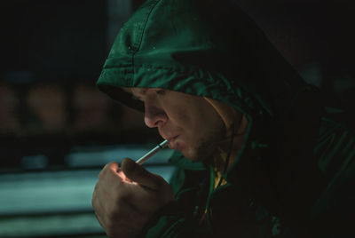 Portrait of man holding cigarette