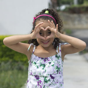 Portrait of girl wearing pink mask