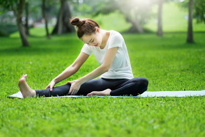 Rear view of man sitting on field